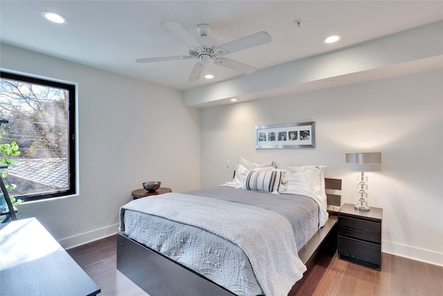 bedroom with ceiling fan and dark hardwood / wood-style floors