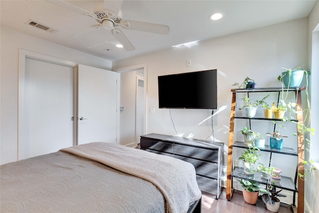 bedroom with ceiling fan and wood-type flooring