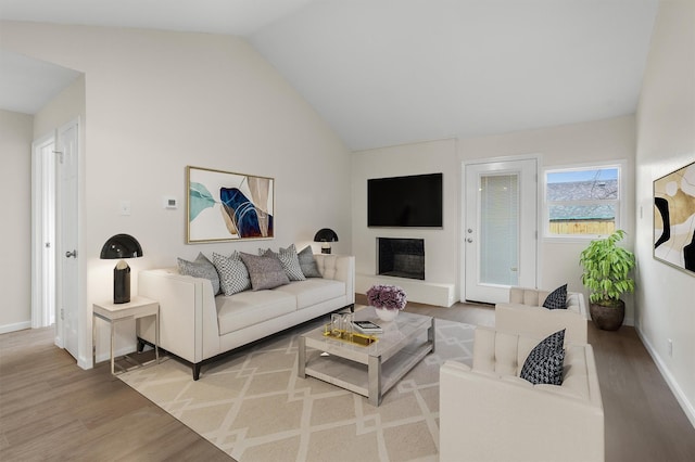 living room with vaulted ceiling and hardwood / wood-style floors