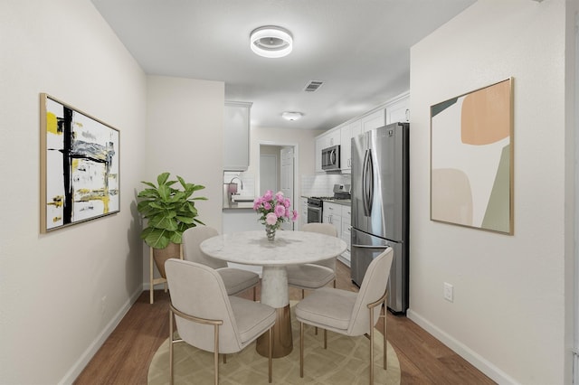 dining area featuring hardwood / wood-style floors and sink