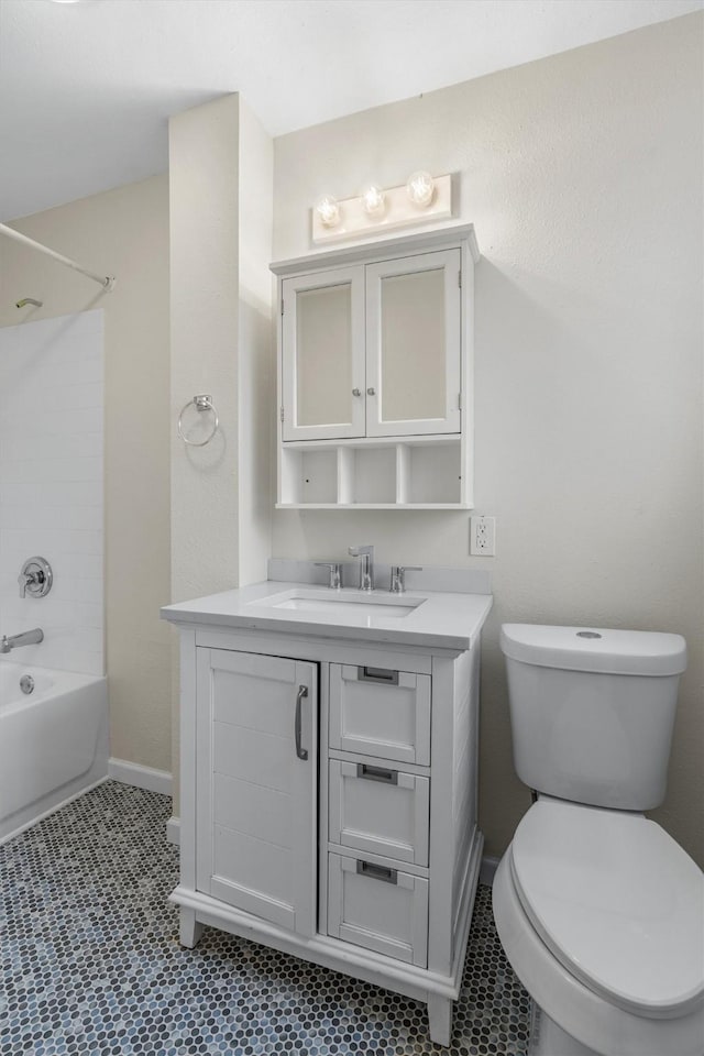 full bathroom with washtub / shower combination, toilet, tile patterned floors, and vanity