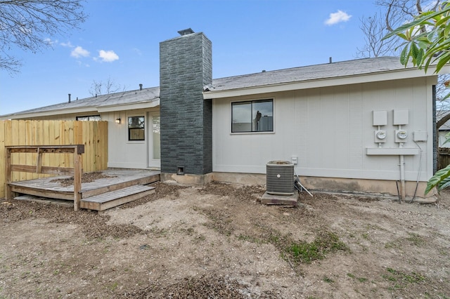 rear view of house featuring central AC unit