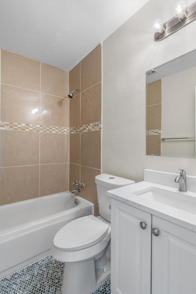 full bathroom with tiled shower / bath combo, vanity, and toilet