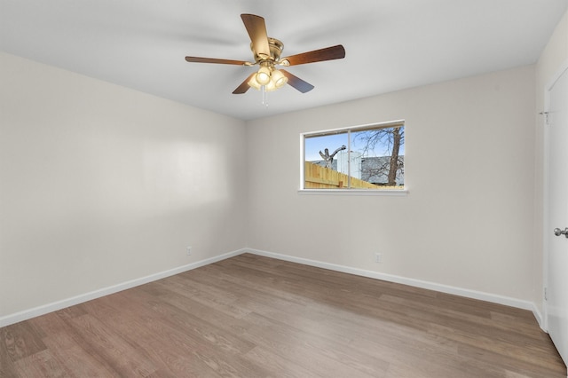 empty room with hardwood / wood-style flooring and ceiling fan