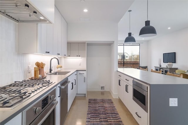 3008 Sorin St, Austin, TX 78723 - kitchen with range hood, a sink, stainless steel appliances, backsplash, and light countertops