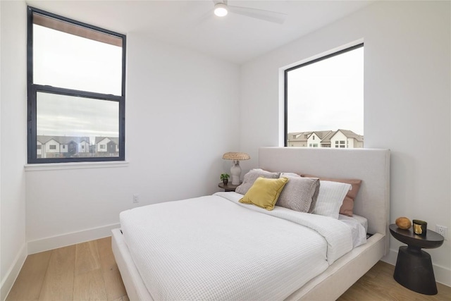 3008 Sorin St, Austin, TX 78723 - bedroom with multiple windows, wood finished floors, baseboards, and a ceiling fan