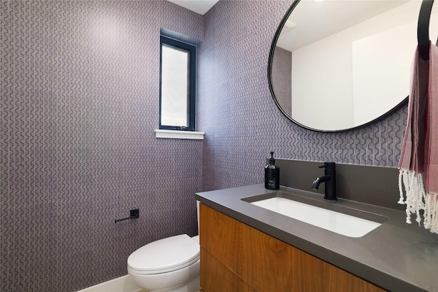 3008 Sorin St, Austin, TX 78723 - half bathroom with wallpapered walls, toilet, and vanity