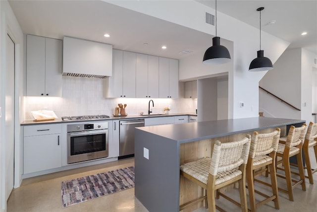 3008 Sorin St, Austin, TX 78723 - kitchen with stainless steel appliances, a sink, wall chimney exhaust hood, tasteful backsplash, and a breakfast bar