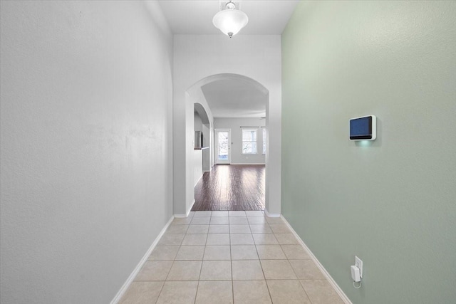 hall with light tile patterned floors