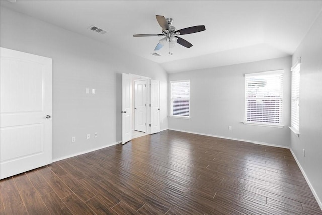 spare room with lofted ceiling, dark hardwood / wood-style flooring, and ceiling fan