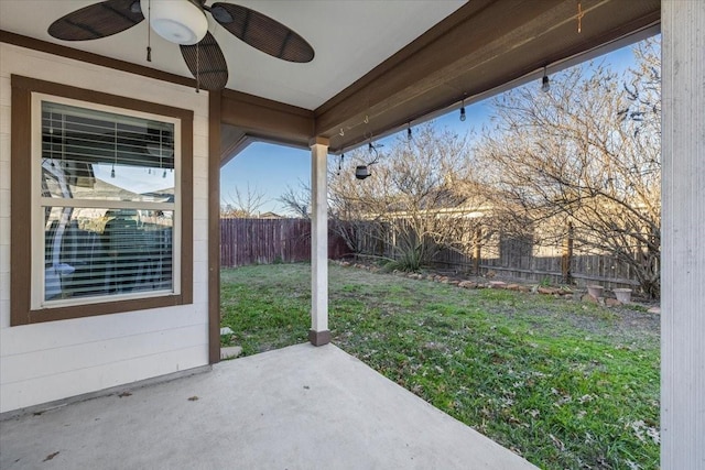 view of yard with ceiling fan and a patio