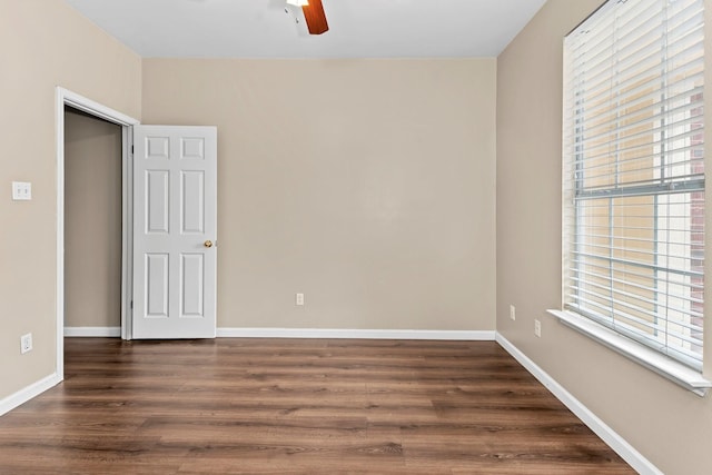 unfurnished room with ceiling fan, a healthy amount of sunlight, and dark hardwood / wood-style floors