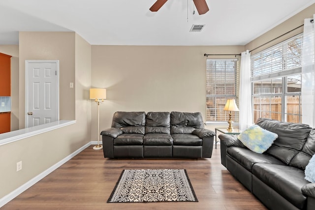 living room featuring ceiling fan and hardwood / wood-style floors