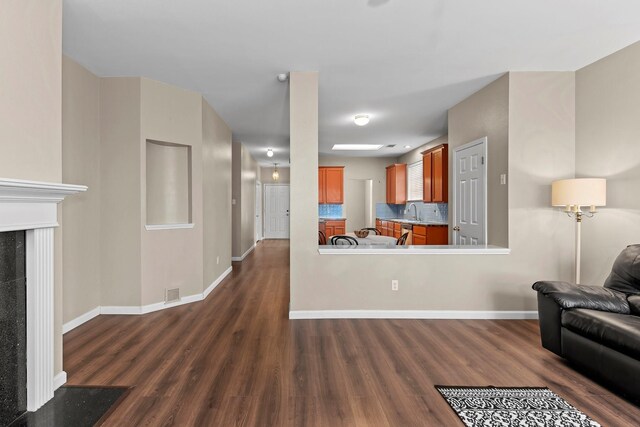 living room featuring sink and dark hardwood / wood-style flooring