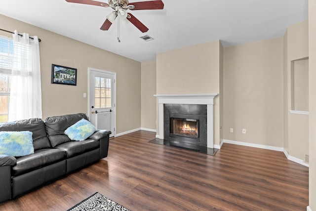 living room with ceiling fan and dark wood-type flooring