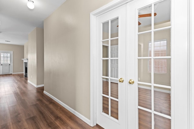 corridor featuring dark hardwood / wood-style flooring and french doors