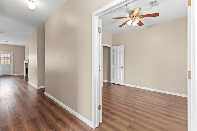 hallway with dark hardwood / wood-style flooring