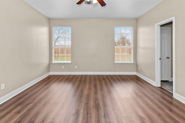 unfurnished room with ceiling fan and dark wood-type flooring