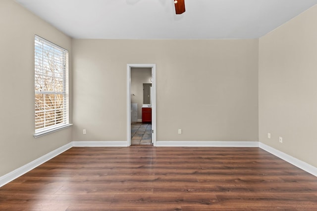 unfurnished room featuring ceiling fan and dark wood-type flooring