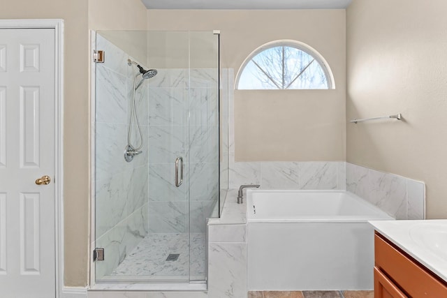 bathroom with separate shower and tub and vanity