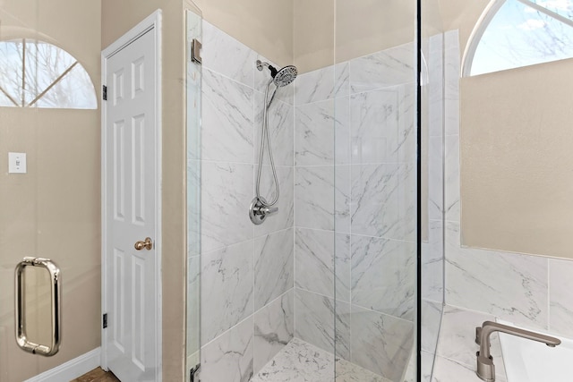 bathroom featuring a shower with door