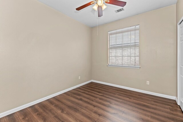 unfurnished room with dark hardwood / wood-style flooring and ceiling fan