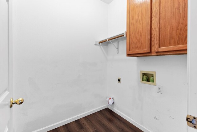 laundry area with dark hardwood / wood-style flooring, electric dryer hookup, washer hookup, and cabinets