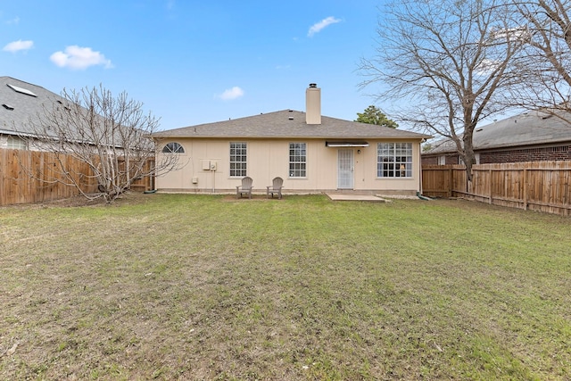 rear view of house with a yard and a patio