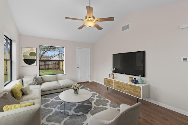 living room featuring ceiling fan, dark hardwood / wood-style flooring, and vaulted ceiling