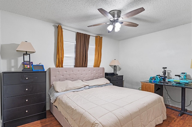 bedroom featuring a textured ceiling, ceiling fan, and dark hardwood / wood-style flooring