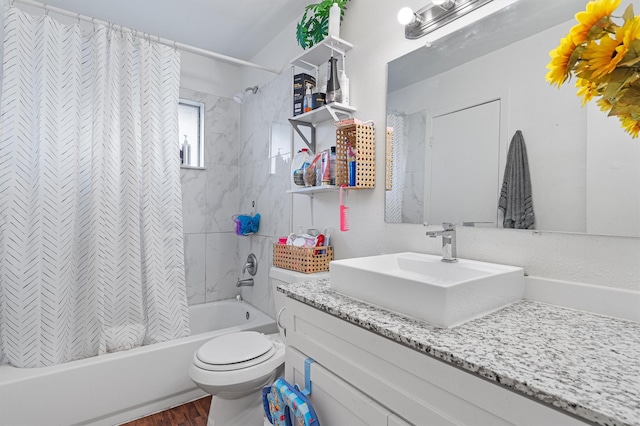 full bathroom featuring toilet, wood-type flooring, vanity, and shower / bath combo