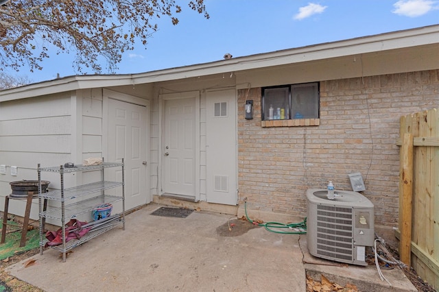 doorway to property featuring a patio and cooling unit