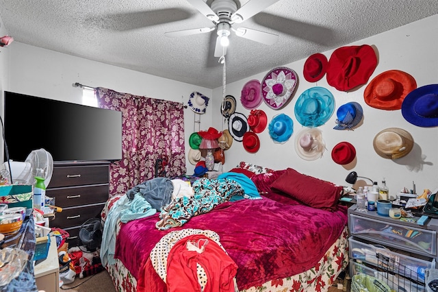 carpeted bedroom featuring a textured ceiling and ceiling fan