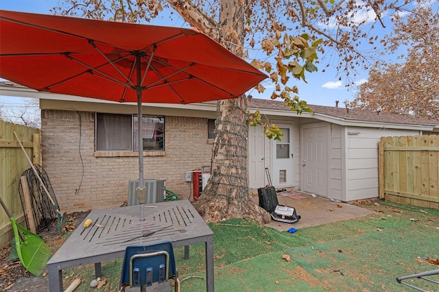 rear view of house featuring a lawn, a patio area, and central air condition unit