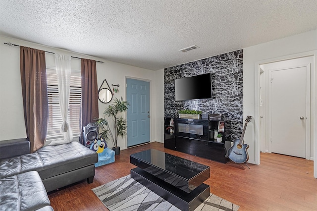 living room with hardwood / wood-style flooring and a textured ceiling