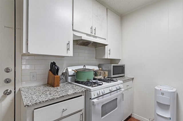 kitchen with white cabinetry, a textured ceiling, light stone counters, backsplash, and gas range gas stove