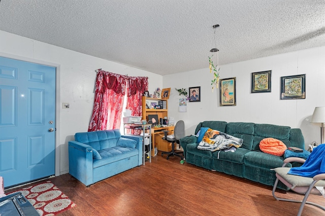 living room with a textured ceiling and hardwood / wood-style floors