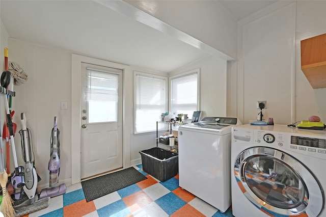 clothes washing area with washer and clothes dryer