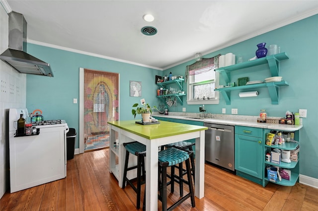 kitchen with extractor fan, a breakfast bar area, ornamental molding, stainless steel dishwasher, and light hardwood / wood-style floors