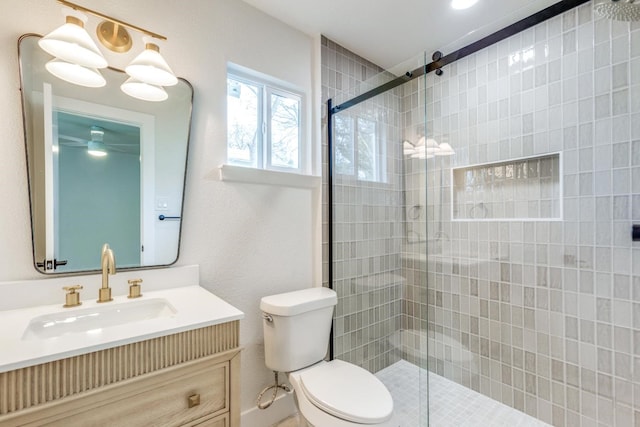 bathroom featuring toilet, a shower with door, and vanity