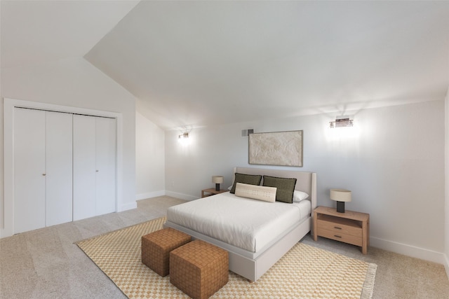 bedroom featuring a closet, lofted ceiling, and carpet flooring