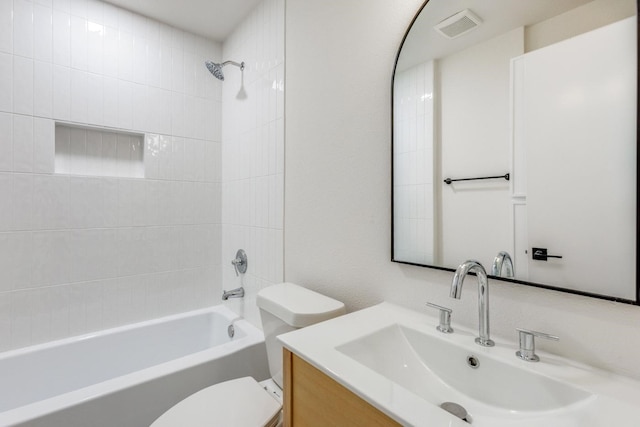 full bathroom with toilet, tiled shower / bath, and vanity