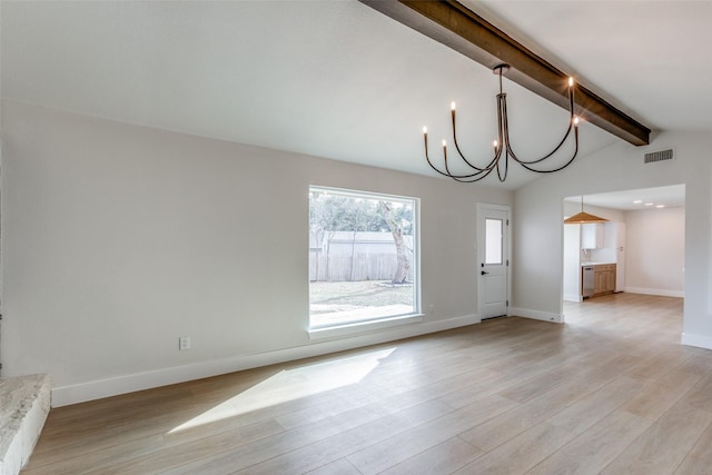 interior space featuring lofted ceiling with beams, light hardwood / wood-style flooring, and a chandelier