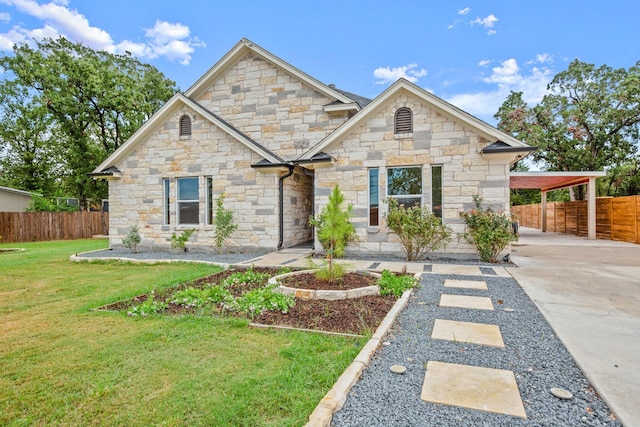 view of front of house with a carport and a front lawn