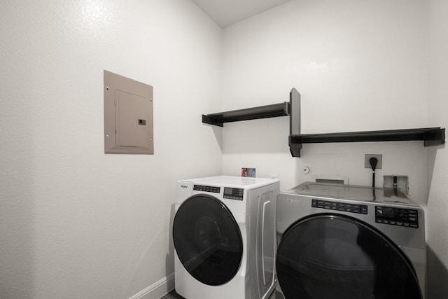 washroom with washing machine and clothes dryer and electric panel