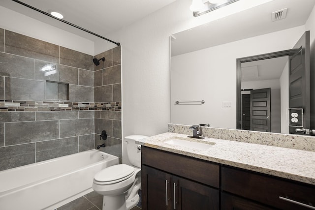 full bathroom featuring toilet, tile patterned flooring, tiled shower / bath, and vanity