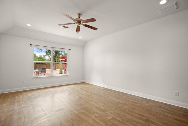 unfurnished room featuring ceiling fan, hardwood / wood-style floors, and vaulted ceiling