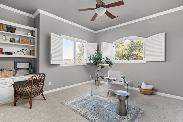 office featuring ceiling fan, ornamental molding, and light carpet