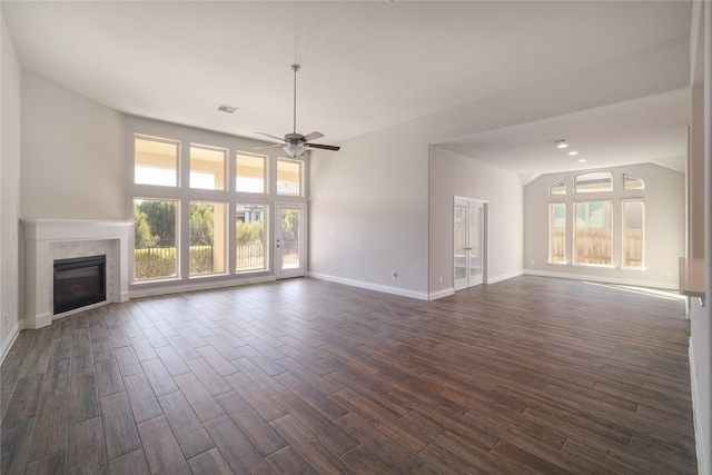 unfurnished living room featuring ceiling fan and a wealth of natural light