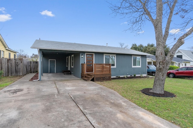 ranch-style house featuring a front yard and a carport